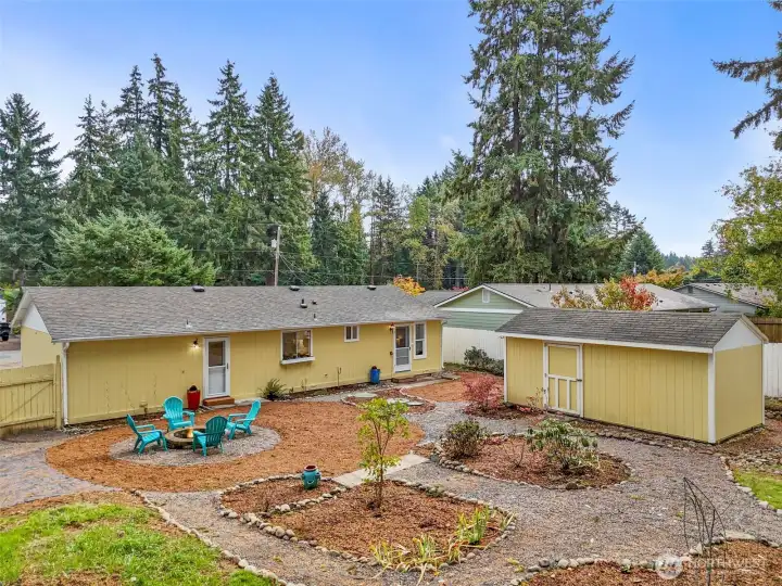 Spacious backyard with garden space, fire pit area, and your own large shed that could be your sanctuary!