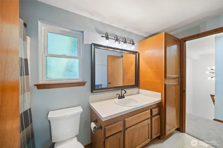 Full bath on upper floor serves both bedrooms. Updated fixtures, lighting, toilet.