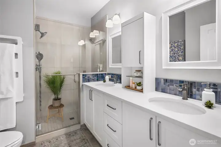 Primary bathroom fully remodeled with dual vanity and dual shower heads.