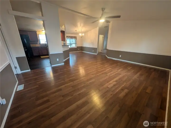 View from the front door into the living room, the HUB of the house. Down to the right is 2 of the bedrooms, the full bath and the 2nd living room. To the left is the primary bedroom and bath suite.