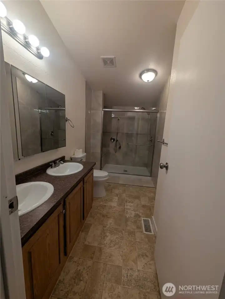 Primary bathroom with double sinks, updated/upgraded shower and lots of light!