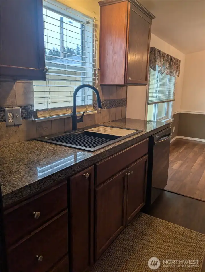 Nice big farm sink, window into the side yard and lots of natural light!