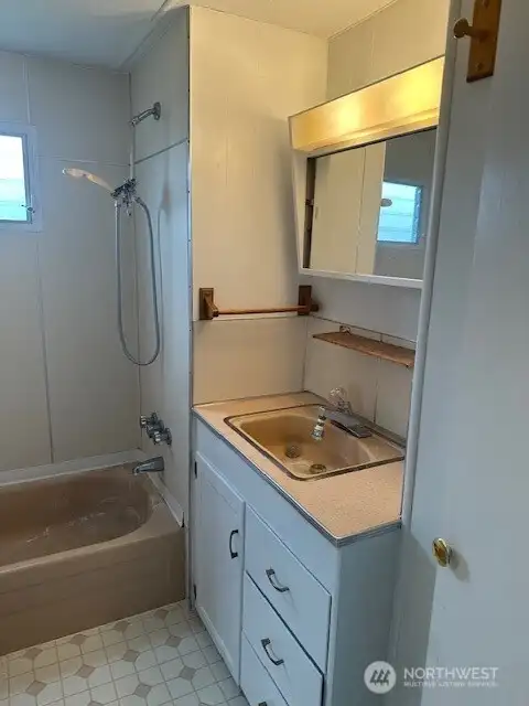 The main bedroom and other bedroom share a full bathroom area.