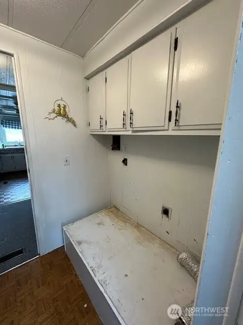 From the kitchen you can exit the home to the patio or garage area.  The laundry is in this exit area.