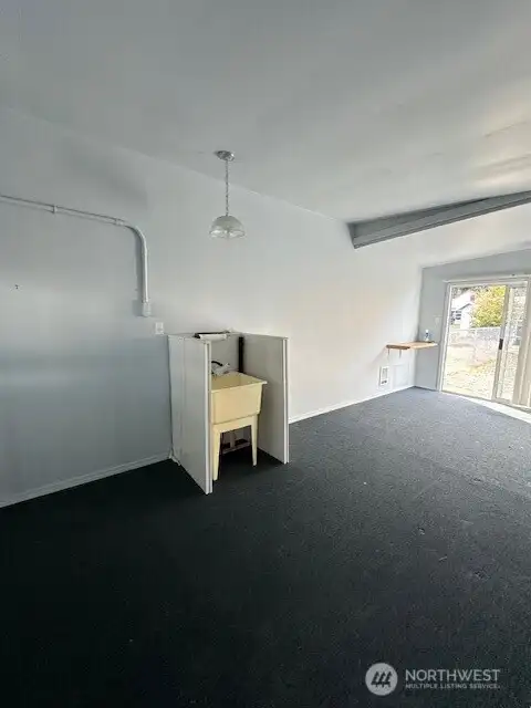 The other side of the garage structure with a sink basin.