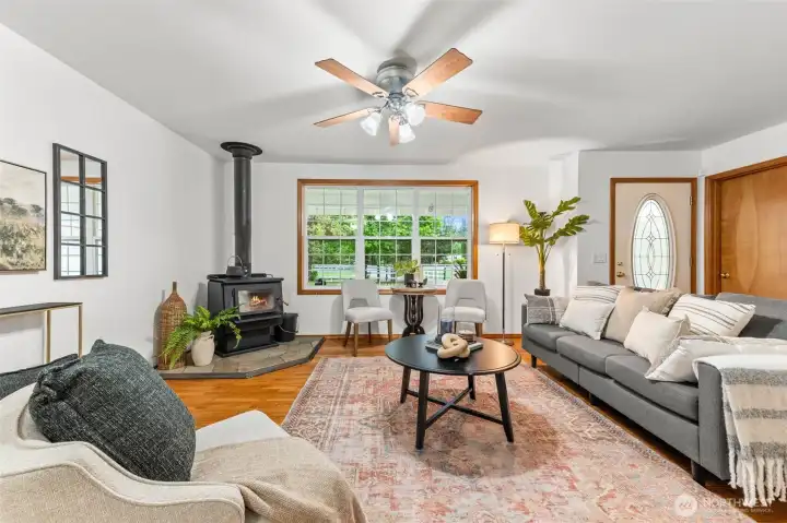 Cozy wood stove, fresh paint, ample natural light and beautiful hardwood floors.