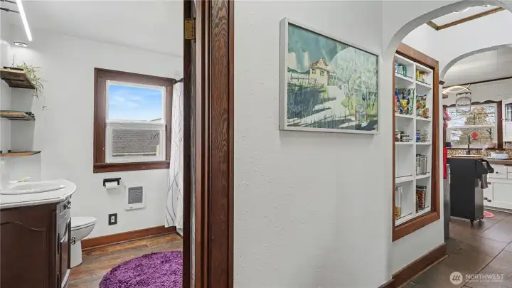 Bathroom is conveniently located near the living room and kitchen.