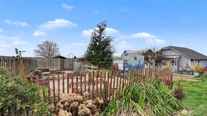 Situated on approximately 1/3 of an acre, the yard is surrounded by mature landscaping and features a garden area.