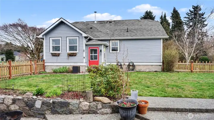 Another view of the backyard with large grass area.