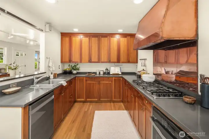 Stunning kitchen with copper backsplash, copper hood and beautiful cabinets. Stunning kitchen with copper backsplash, copper hood and beautiful cabinets.