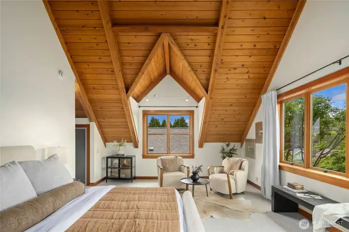 Cathedral ceilings make the primary bedroom a true showstopper. Cathedral ceilings make the primary bedroom a true showstopper.
