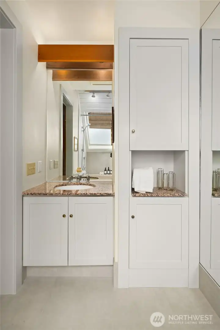 Fir trim and beautiful custom cabinetry grace the upper floor bathroom. Fir trim and beautiful custom cabinetry grace the upper floor bathroom.