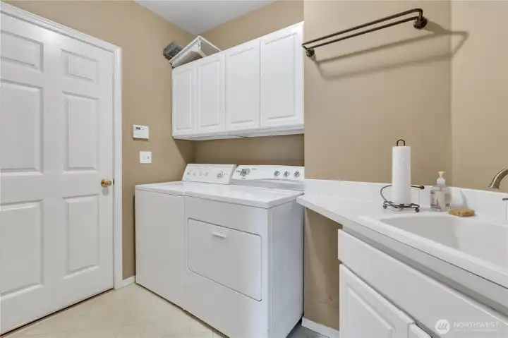 Utility room with laundry and sink
