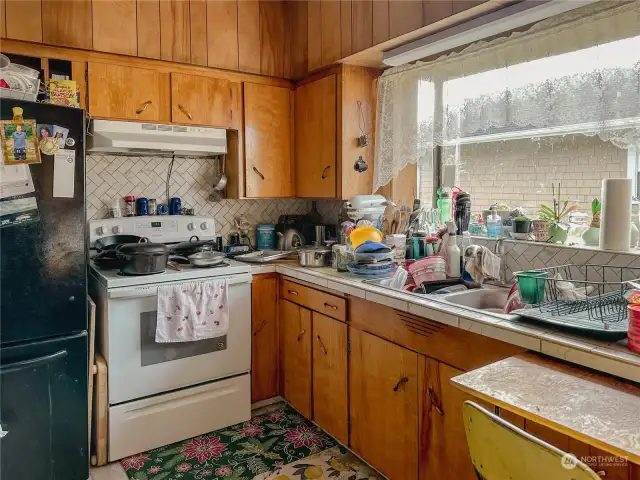 Nice backsplash. Kitchen is more spacious than appears in photo.