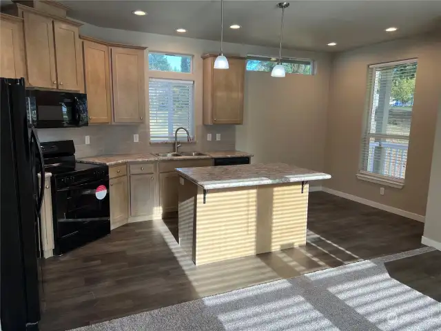 Kitchen with island and eating area.