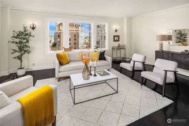 Extremely generous living room features high ceilings, parquet hardwoods + large windows that capture views to the north + east. This rooms leads graciously to the dining room and kitchen.