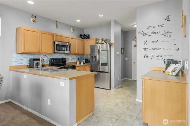 To the right is a kitchen walk in pantry and access to the garage and 1/2 bath