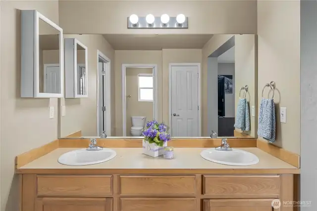 Primary Bathroom double sinks, bath, shower, and linen closet