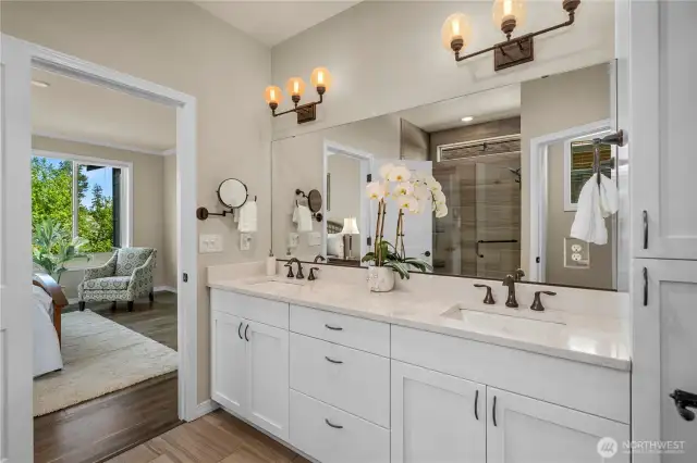 Primary bath is pristine and timeless with light Quartz counters, oil rubbed bronze fixtures, classic white cabinetry & tile flooring.