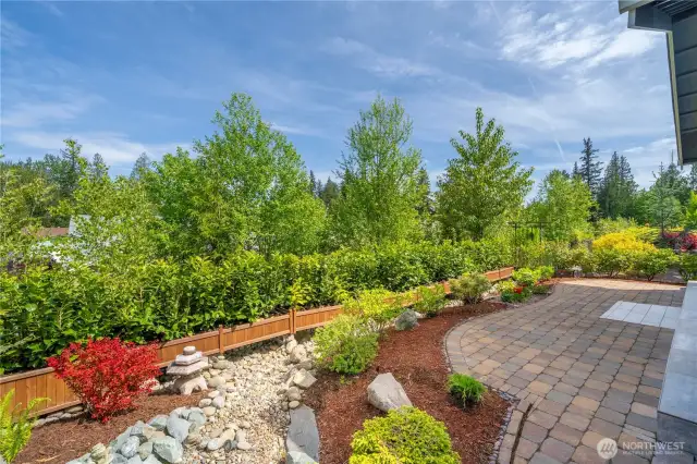 Extensive hardscape & thoughtful plantings.  Fully irrigated landscaping and privacy trees which will only get taller and create even more privacy.