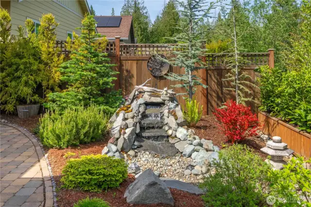 Custom water fall feature creates a soothing ambiance while enjoy the beautiful vistas from the backyard.  Also on a timer.