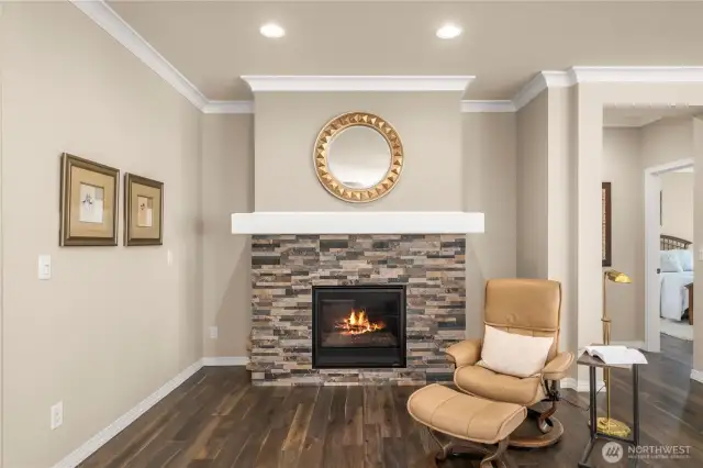 Custom fireplace with mantle and tasteful crown molding creates an elegant space to enjoy.