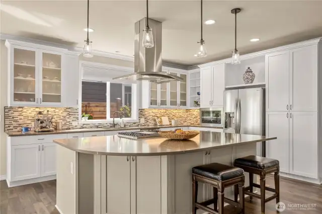 Designer pendants, elegant hood vent, bathed in natural light and plenty of storage.