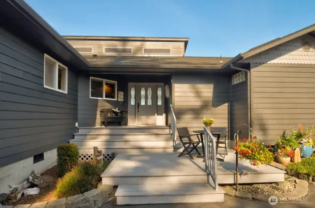 welcoming front porch with cozy seating, clean lines and charming details for relaxed coastal living