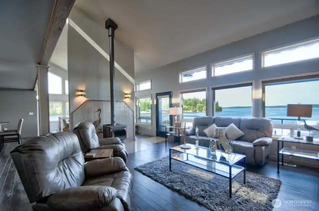 step inside to soaring ceilings, warm natural light and stunning water views that instantly steal your breath
