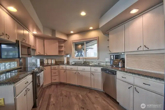 warm spacious kitchen with custom cabinetry with stylish backsplash perfect for everyday living and hosting