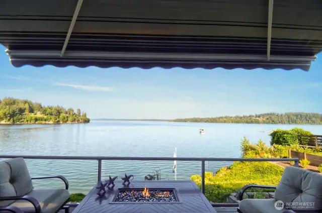 unwind fireside on your deck with sweeping water views, passing boats and tranquil PNW beauty all around