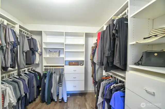 spacious walk in primary closet with custom built-ins, abundant storage and organized elegance for everyday ease