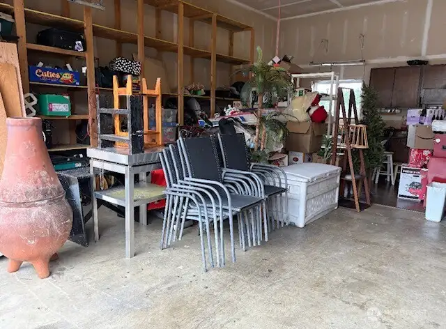 spacious garage with built -in shelving, perfect for organized storage, hobbies or gear for waterfront living just outside laundry room