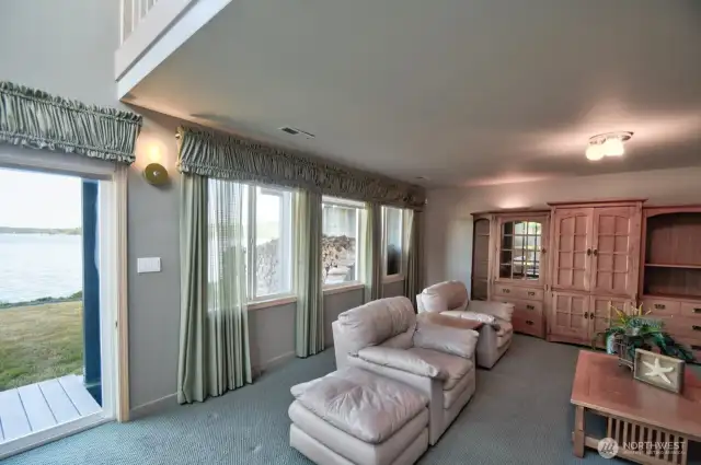 Cozy walk out basement with large windows showcasing the panoramic views- perfect for those guest that love coming to the bay