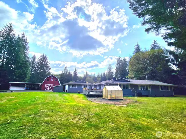 Backyard view of barn & greenhouse