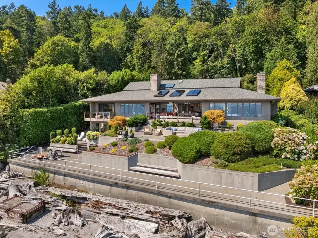 Thoughtfully designed for seamless indoor-outdoor living, the home features expansive waterfront patios, lush grounds and an ambiance of tranquility and sophistication.