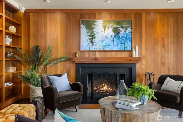 Beautiful built-ins along the wall, teak mantel and stone fireplace surround creating the perfect conversation setting.