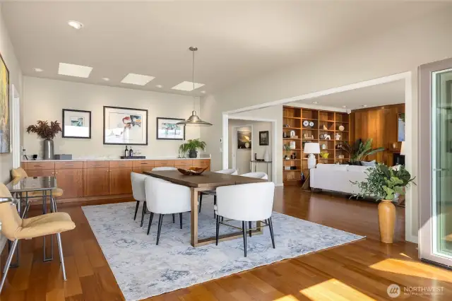 The dining room is center-stage with a bank of service cabinets and sideboard buffet.
