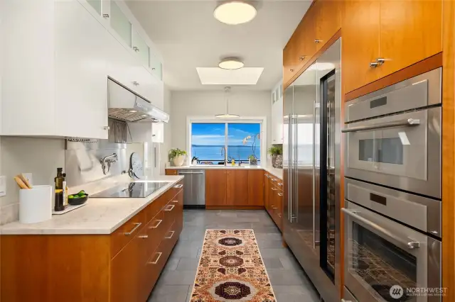 A recently remodeled kitchen features Beautiful leathered quartz counters: cherry cabinetry: Sub-Zero refrigerator and wine storage; induction cook-top;
