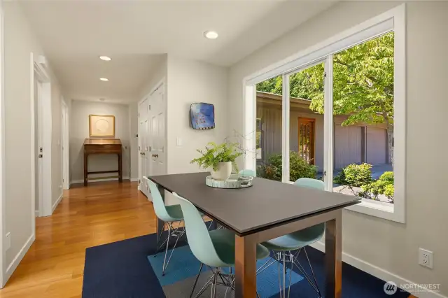 The interior breezeway connecting the guest area and primary suite offers casual dining overlooking center courtyard gardens.
