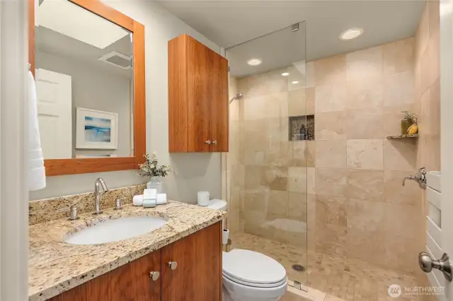 Guest Bath #2, features a step in shower with tumbled marble &  granite counters.