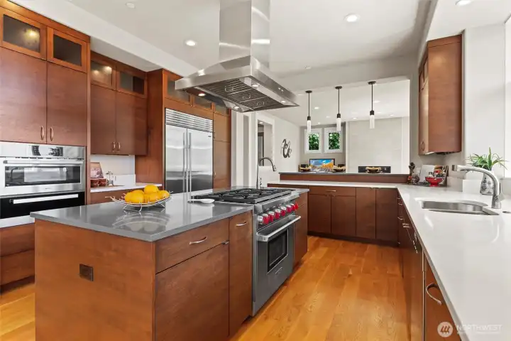 Large chef’s island kitchen with breakfast bar is equipped with top-tier Wolf, Miele, and SubZero appliances & walk-in pantry