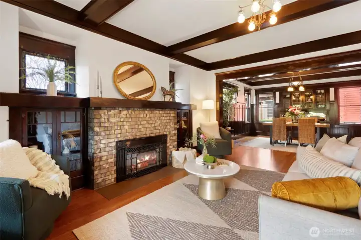 Gas fireplace, glass tiles encompassed by original built-ins, accented with stain glass windows