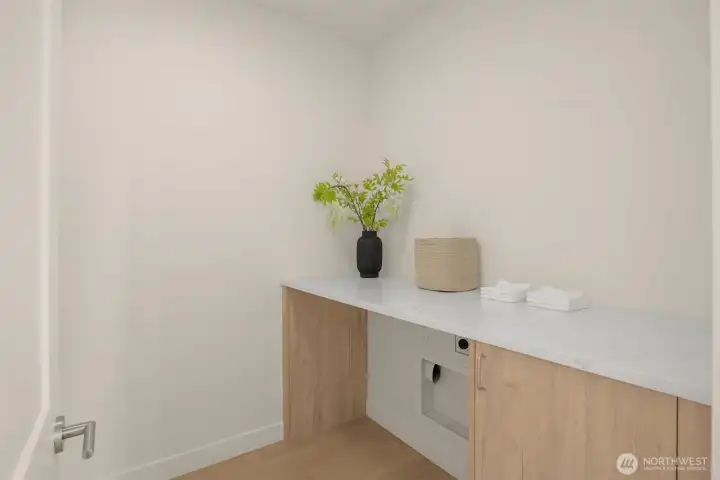 Laundry room with quartz countertops.