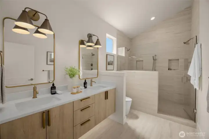 Primary spa-inspired bath with dual vanities & dual showerheads.