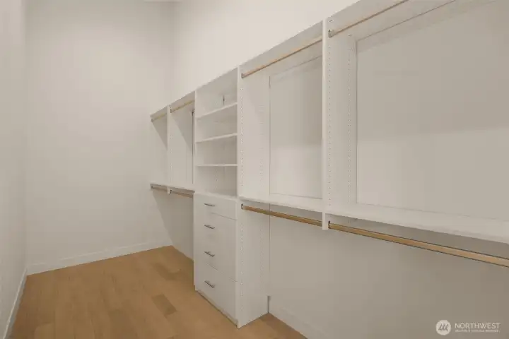 Boutique-style walk-in closet with custom shelving.