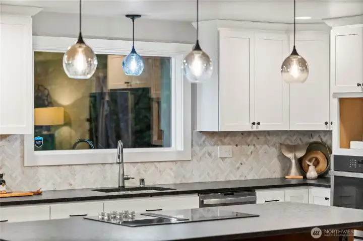 tile splash back and the honed black granite slab counter tops