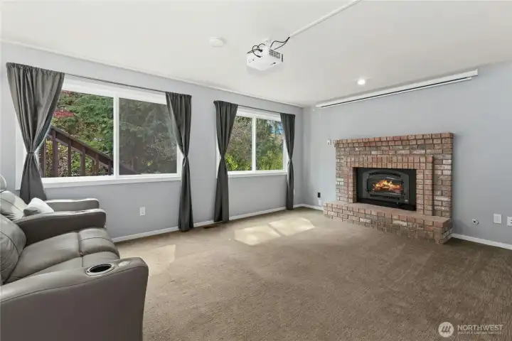 Lower-level living area with cozy brick fireplace