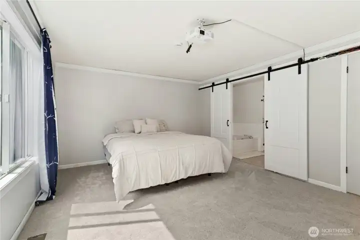 Spacious primary bedroom with natural light