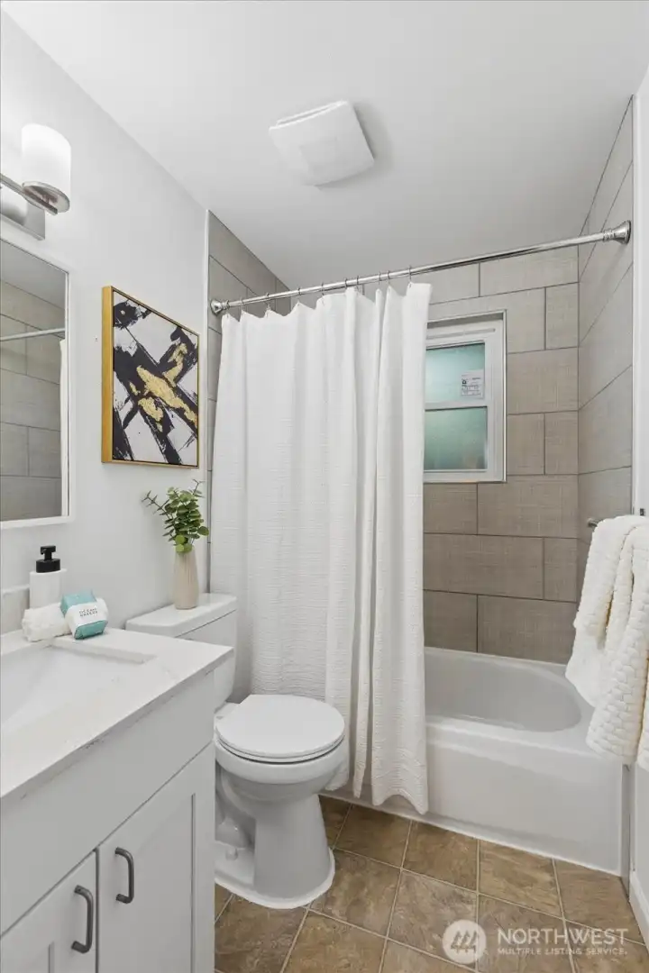 Bath has new flooring, new window and toilet.